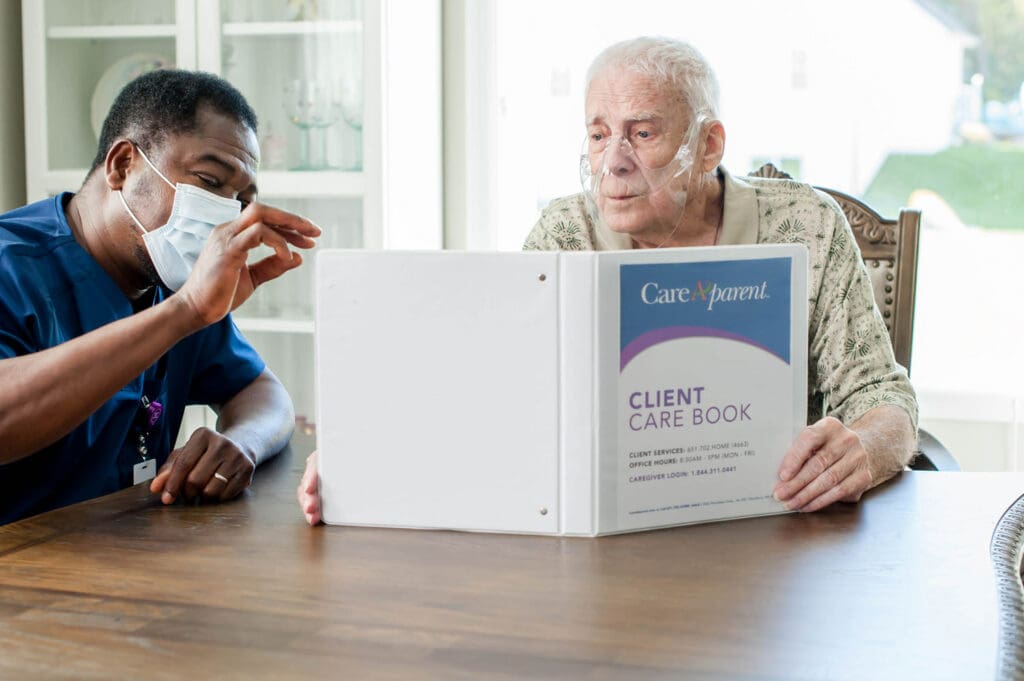 Male nurse reviewing care plan with senior patient